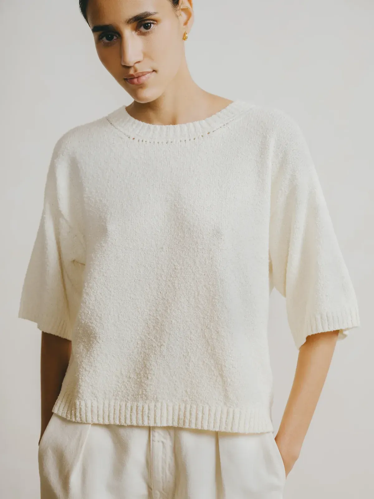OZMA Spring 2025 — ivory short-sleeve knit top