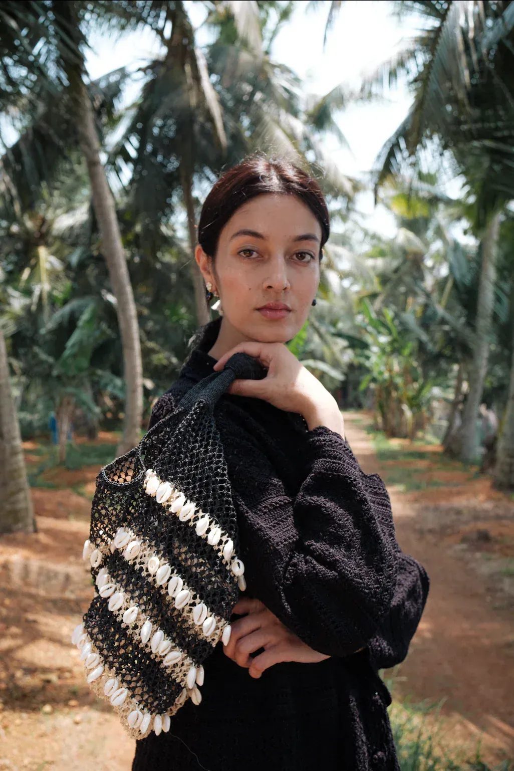 Hand-woven macramé bag with cowrie shells