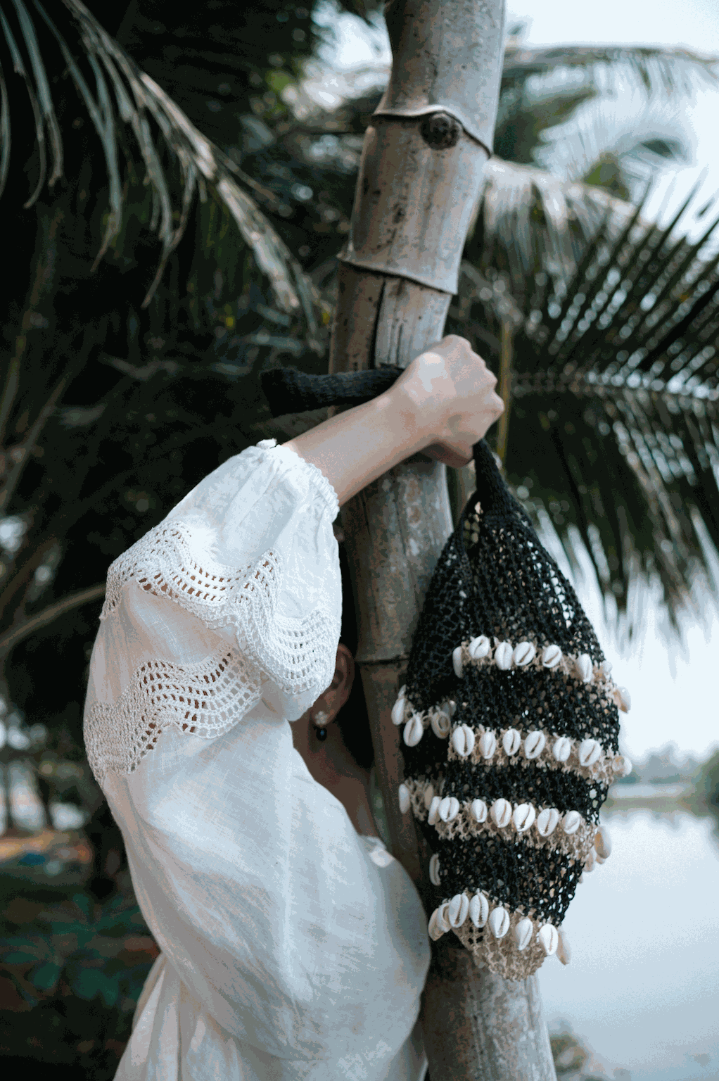 Macramé shoulder bag with cowrie shell trim